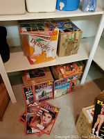 Four cardboard boxes of Time magazines on shelf with loose issues in front