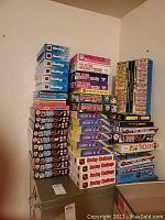 Stack of approximately 40 hockey-themed puzzle boxes in various brands and themes including Waddingtons and Marathon.