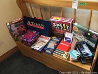 Photo showing all games together including Pictionary, Cranium, Split Decision, Memory, and other card/cardboard boxed games