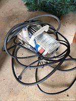 Top view of the compact Campbell Hausfeld Power Pal air compressor with power cord coiled around it.