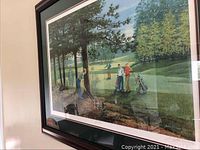 Framed print hung on wall showing four men playing golf with golf bags and trees in the background