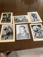 Six hockey cards laid out on table showing front black and white images and beige backing.