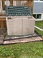 Front view of the storage shed with lid open showing outside appearance