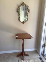 Photo showing the wooden side table with turned pedestal base and tripod feet