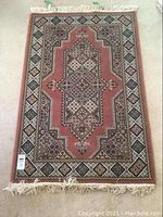 Full view of Persian style carpet showing entire rectangular piece with fringe edges and central medallion design