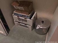Boxes stacked next to the aluminum canning pot showing lot contents