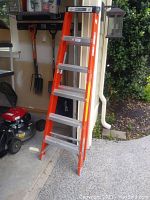 Photo showing the full 6ft orange Industrial Lite step ladder with aluminum steps.