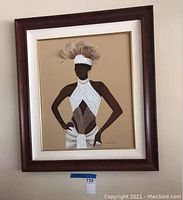 Full shot of the framed June Marie wall art showing the portrait of a woman dressed in white with feathers in headpiece.