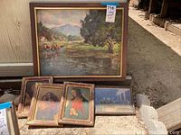Group of six framed artworks including one large landscape and five smaller religious prints.