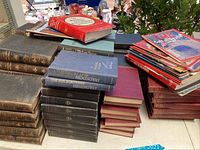 Wide view of vintage hardcover books stacked together including Hemingway titles and other volumes