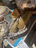 Photo showing sterling silver brush set including hair brushes and hand mirror on a silver tray