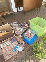 Plastic bins and cardboard boxes filled with assorted sports trading cards