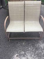 Front view of two seater porch swing showing metal frame with rust and beige fabric seats.