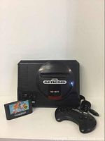 Front view of Sega Genesis console, controller and Sonic the Hedgehog 2 cartridge showing overall condition