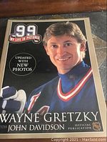Cover photo of the book showing Wayne Gretzky in a hockey jersey, with text noting updated new photos and co-author John Davidson.
