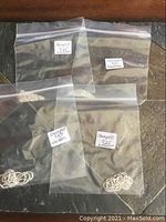 Four clear plastic resealable bags each containing a silver ball chain necklace marked 925 with white labels indicating 'Stamped 925 Necklace'.