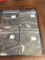 Four clear plastic bags containing sterling silver chains, each bag labeled 'Stamped 925 Necklace'.