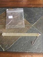 Full view of a wide multi-row rhinestone bracelet laid flat showing length and clasp.