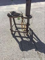 Full view of antique wooden saddle tree showing angled view with padded fur seat and wooden frame
