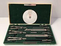 Alpha 2208 drafting tools set inside green velvet-lined case with magnetic closure, all items neatly arranged and visible.