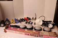 Overview of all items including 15 flashlights, two spotlights, vanity strip light box, and Sony battery charger
