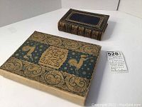 Both hardcover books side by side on white background