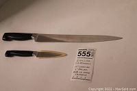Two knives side by side, showing the large 10 inch carving knife above and smaller 3 inch paring knife below with original sheath visible.
