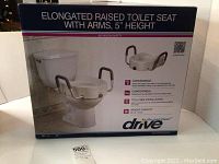 Box image showing the labeled brand 'Drive' and product features such as convenience, comfort, tool-free installation, and weight capacity. The product is an elongated raised toilet seat with arms and 5 inch height.