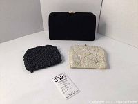 Three vintage evening bags displayed together, showing front views and sizes with tag