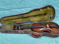 Open case showing violin body and interior layout