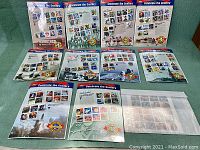Full view of 10 Celebrate the Century USPS stamp sheets plus one additional sheet, all in mint condition.