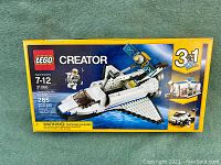 Front view of the LEGO box featuring the space shuttle model and box's primary design.