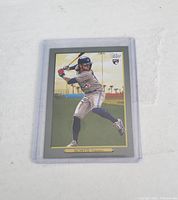 Bo Bichette Topps rookie card front showing player in batting stance outdoors with a palm tree background, in protective sleeve.