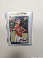 Front view of the Chipper Jones rookie card showing player image, team, logos, and rookie card designation with gold foil text.