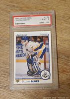 Front of PSA graded 1990 Upper Deck #175 Curtis Joseph rookie card showing Curtis in blues goalie gear, card graded EX-MT 6 with PSA label and serial number.
