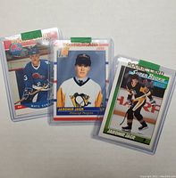 Three rookie hockey cards encased in plastic sleeves, showing front images of cards for Jaromir Jagr and Mats Sundin in team uniforms.