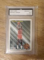 Front of 1993 Fleer Michael Jordan basketball card graded Gem Mint 10 by FGS, showing Jordan shooting in Bulls uniform with League Leader emblem