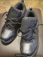 Top view of pair of black New Balance men's athletic shoes showing the lace-up front and overall condition.