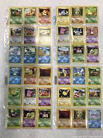 Photo showing front sides of original 1990s Pokémon cards arranged in sleeves. Cards include various characters and 1st Edition symbols.