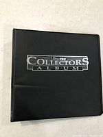 Black Ultra PRO Collectors Album binder containing the Pokemon cards