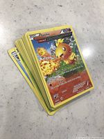Stack of assorted Torchic Pokemon cards with visible front of torchic card.