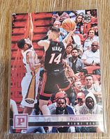 Front of Tyler Herro rookie card showing player in black Miami Heat jersey with basketball action shot and rookie card logo.