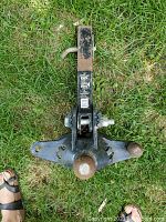 Tractor hitch bar with two ball mounts on grass showing overall condition and shape