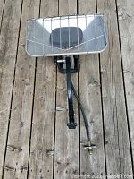 Front view showing rectangular reflector, protective wire cage and propane hose attachment with mounting clamp.