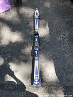 Full length of ski showing blue and white Elan Procarve design with MBC branding on top.