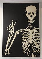 Full view of large skeleton poster on black background, skeleton making OK hand gesture