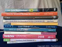Stack of dessert and holiday themed cookbooks showing titles and colorful spines