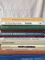 Stack of 9 drawing instruction books showing titles and authors