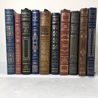 Front view of all 11 Franklin Library full leather first edition books showing colorful gilt decorated spines and silk ribbon bookmarks.