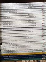 Photo showing stacked Heffel Fine Art Auction House catalogs dated 1999 to 2013 with visible spine titles and dates.